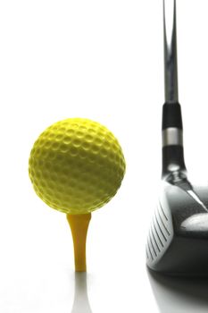 Golf ball and a golf club isolated against a white background