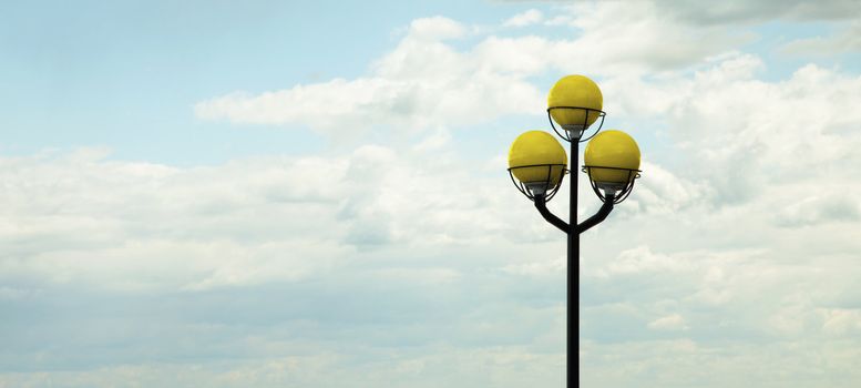 Ancient lamppost against the cloudy evening sky