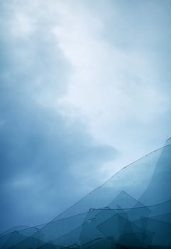 The blue cloudy sky through the broken window