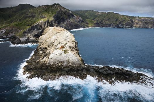 Aerial view of mountains and rocky Maui, Hawaii coastline.