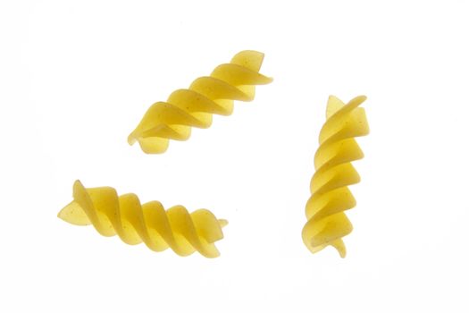 Three pieces of fusilli pasta on a white background.