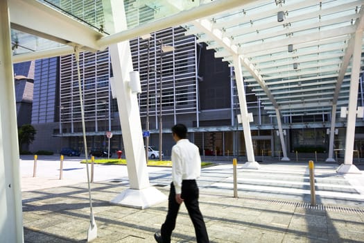 Businessman walking in modern building outdoor