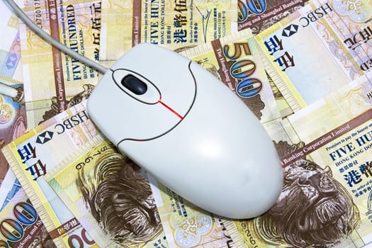 computer mouse placed on $500 hongkong dollar bills 