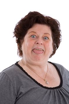Mature woman in her fifties pulling a funny face on white background