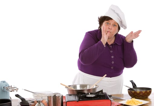 Mature female chef making a sign that her scrambled eggs are delicious