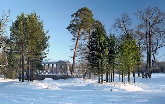 Winter landscape with classical bridge