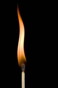 Macro of a burning matchstick flame in the dark