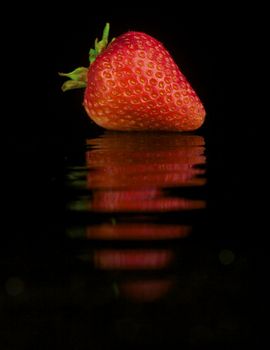 Solitary Strawberry Isolated on Black