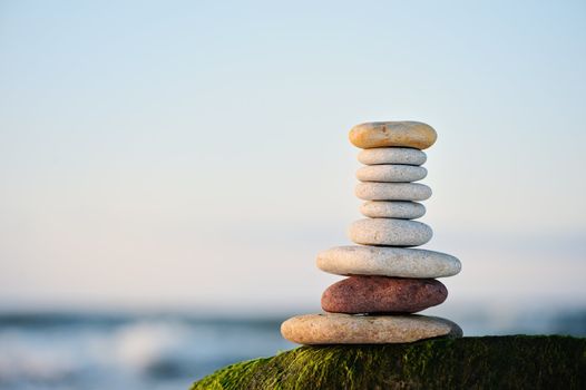 Pile from a sea pebble on a beach early in the morning