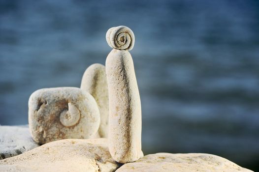 Sea pebble with fossilized cockleshells against ocean