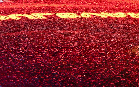 Close up of drops and sign reflection on a glass after raining in Miami Beach