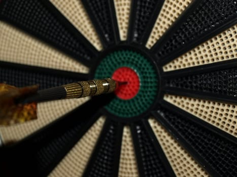 A dart in the middle of the board, a bullseye