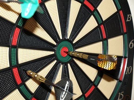Darts thrown at the board with one bullseye