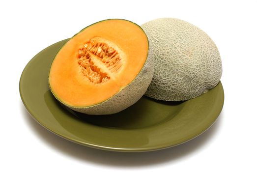 A freshly cut cantaloupe on a dinner plate.