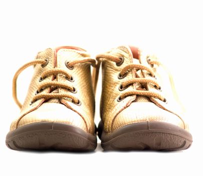 Cute golden baby shoes  isolated on white