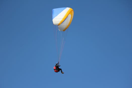 paragliding blue white and orange and sky blue