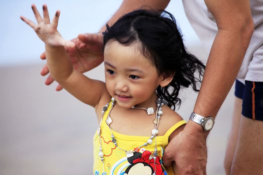 Portrait of the beautiful small Asian girl with father. Indonesia. Java