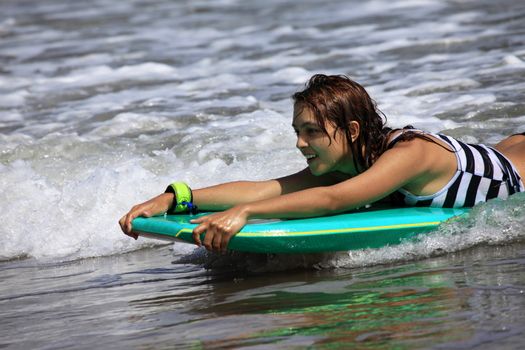 Girl - the surfer in ocean. Bali. Indonesia