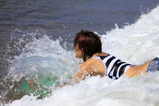 Girl - the surfer in ocean. Bali. Indonesia