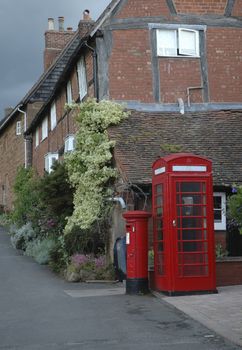 Old village scene with houses, telephone and postbox