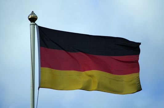 Flag of Germany flying on a flagpole