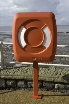 A red lifesaving belt on the sea front