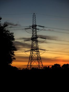 Power lines and pylon at sunset