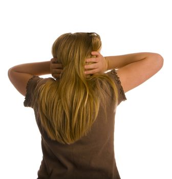 A girl with her back turned and ears covered.