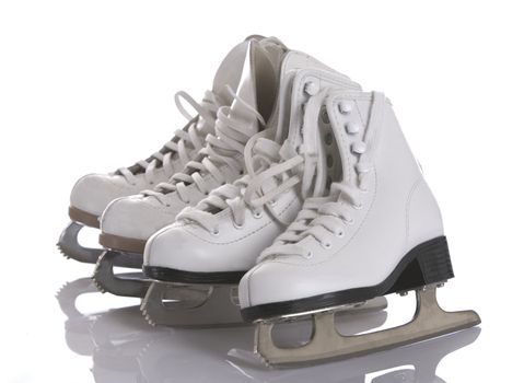 Four figures skates on white and ice background