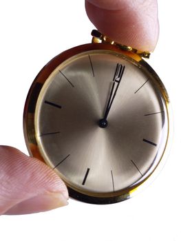 Fingers holding gold pocket Watch, isolated