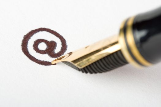 close-up gold pen writing email address