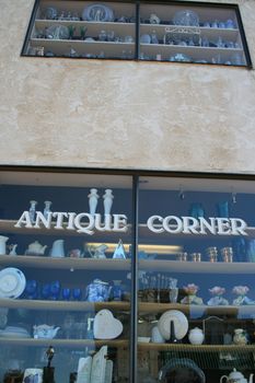 Close up of an antiques sign on top of a store.
