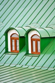 Roof dormers on the roof covered with green iron plates (the Kiev-Pecherskaya Lavra monastery, Kiev, Ukraine)