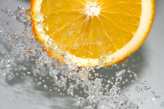 water splashing on a juicy orange