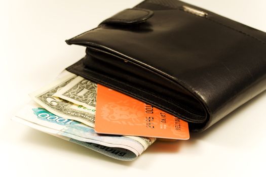 Black leather wallet with bank notes and credit card. Financial concept
