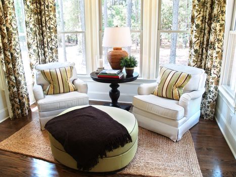 Two comfortable overstuffed chairs in a nicely decorated luxury sunroom