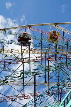 Multicoloured Ferris wheel against blue sky in Sigulda, Latvia