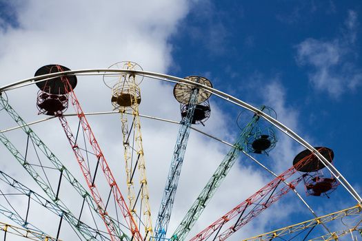 Multicoloured Ferris wheel against blue sky in Sigulda, Latvia