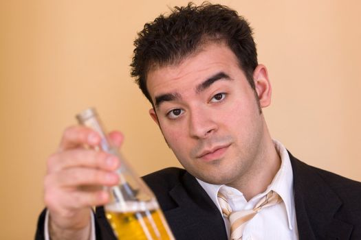 A young business man offering a beer after hours. Benjamin Franklin said that Beer is living proof that God loves us and wants us to be happy. 