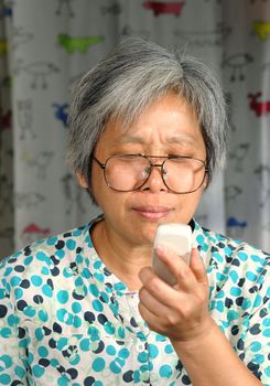 middleage woman looking on phone