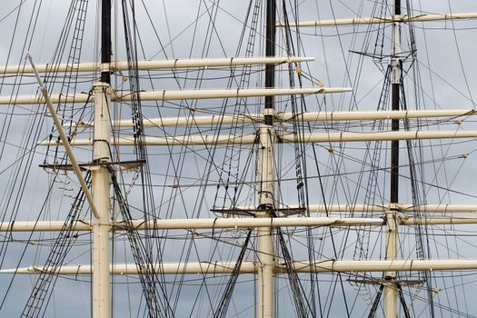 Part of tall ship rigging against dark sky