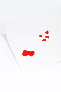 white envelope with hearts over white