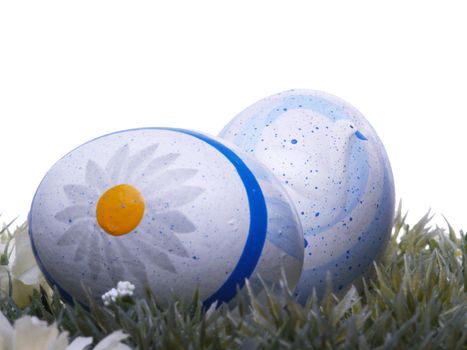 handpainted easter eggs, artificial grass and blossoms, isolated