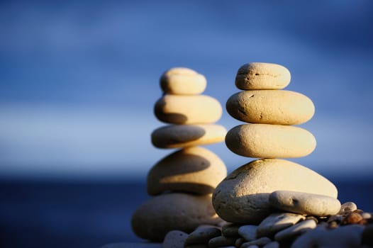 Two stack of pebbles against the blue sky