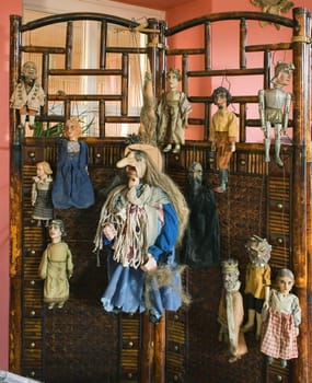 old marionetes hanging on banner-screen