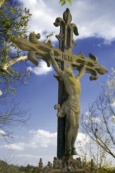 vintage iron crucifix against blue sky