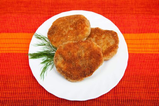 Three cutlets on the white plate