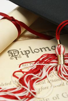 A diploma and grad hat represent a high achieving student.