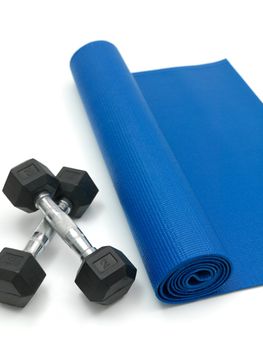 An exercise mat and hand weights isolated against a white background