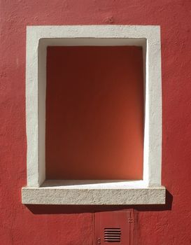 red window hole in a red wall